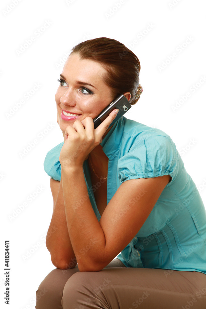 A smiling woman using a mobile phone, isolated on white A smiling woman using a mobile phone, isolated on white