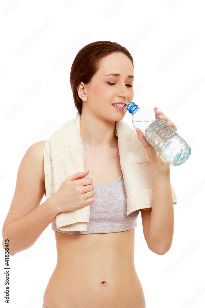 A woman in a sport costume drinking water A woman in a sport costume drinking water