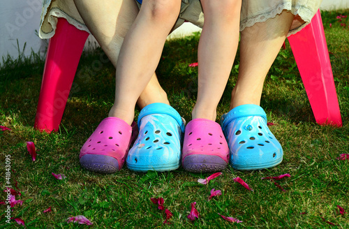 Feet in crocks on grass in colors