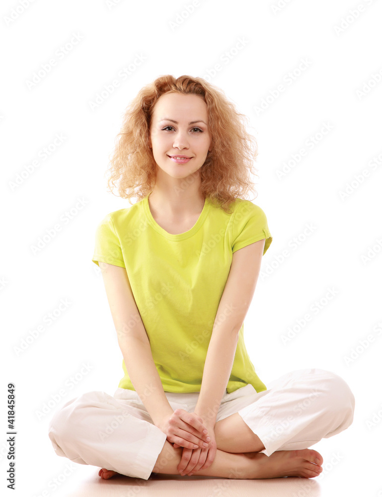 A positive yong woman sitting on the floor A positive yong woman sitting on the floor