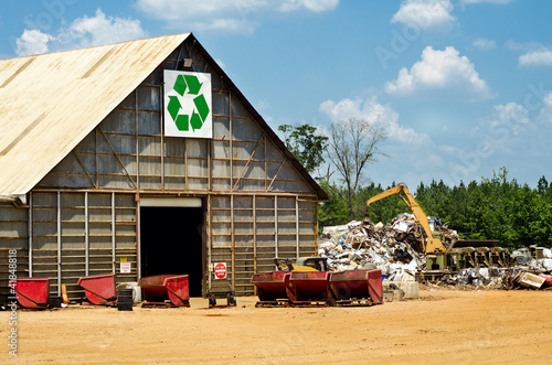 Recycling center with scrap yard and heavy machinery photo