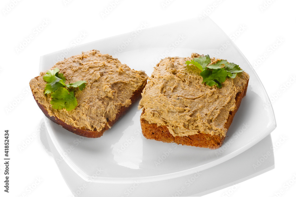 Fresh pate on bread on white plate isolated on white