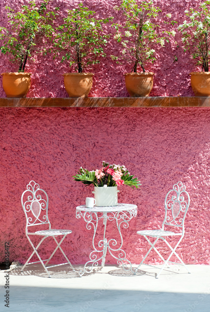 living area, white chair and pink wall