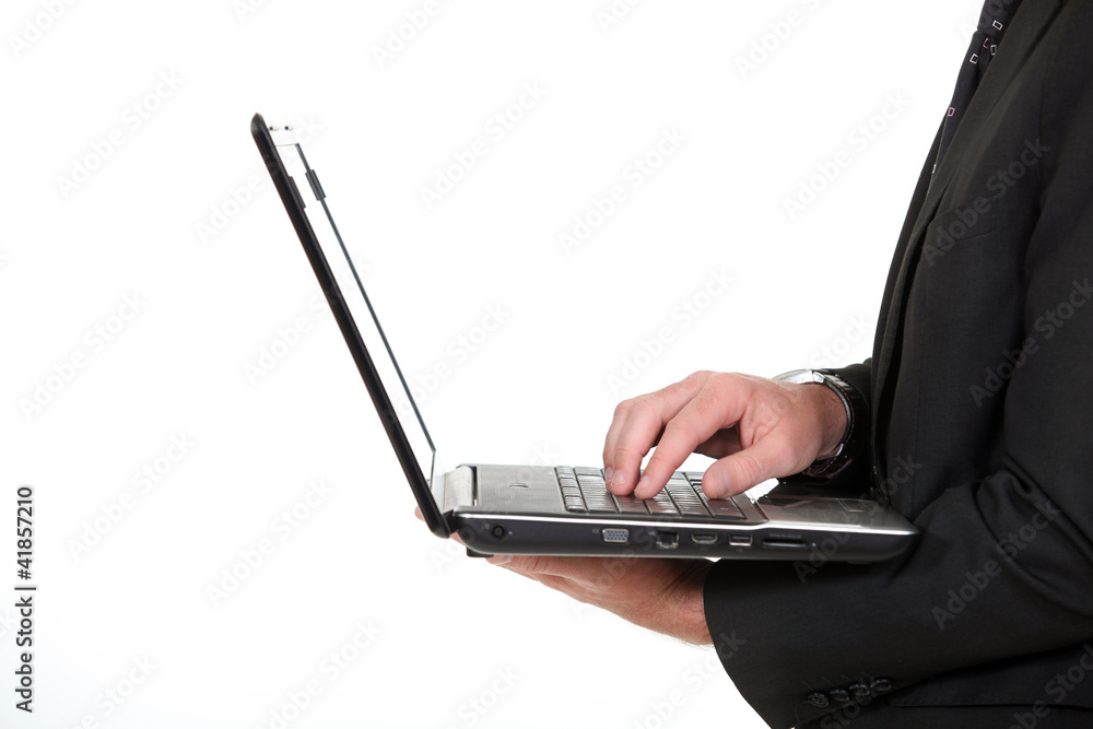 Businessman typing on laptop keyboard Businessman typing on laptop keyboard