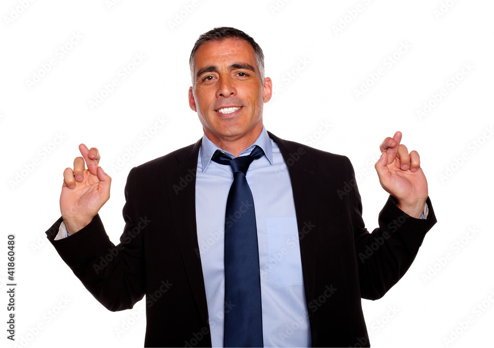 Executive man smiling and crossing the fingers Executive man smiling and crossing the fingers