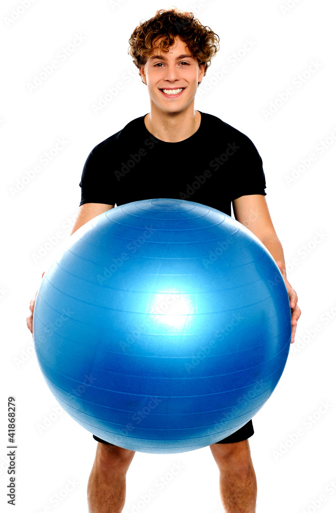 Man in sportswear holding big ball