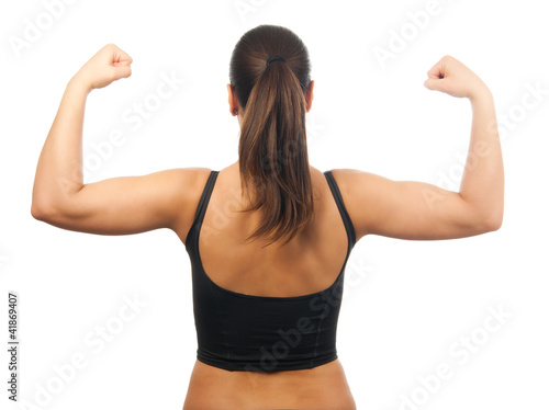 Strong and muscular young woman showing her muscles