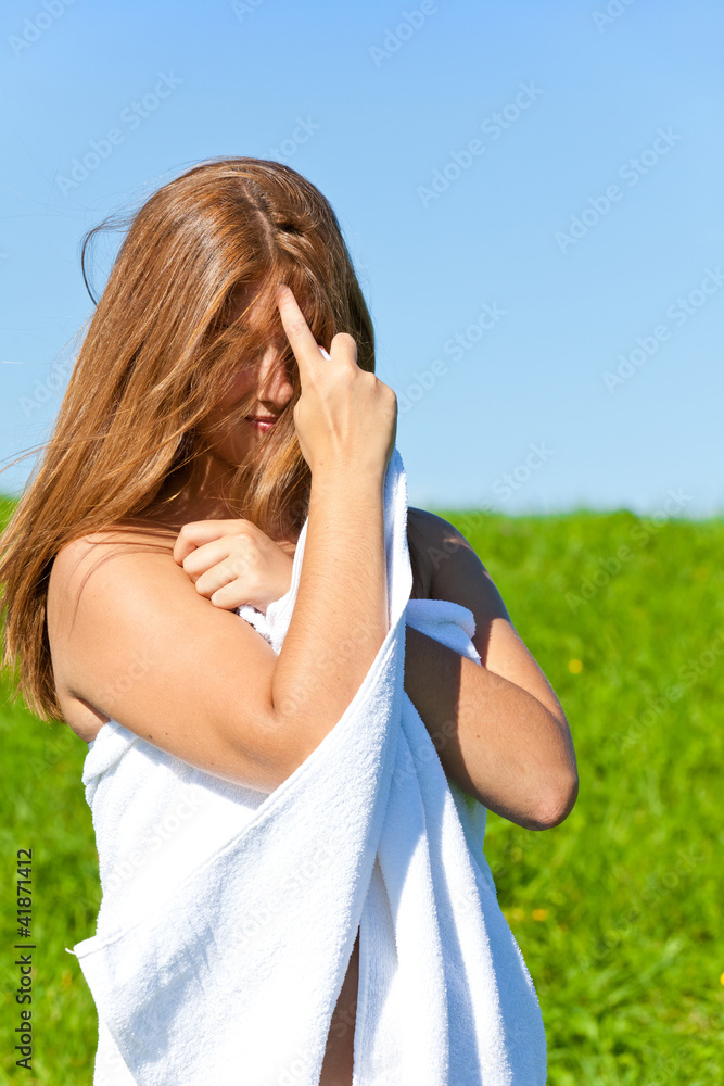 Woman with towel on meadow Woman with towel on meadow