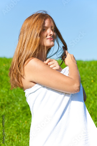 Woman with towel on meadow