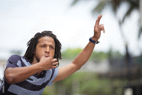 Man whistling for a cab
