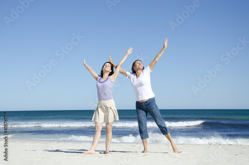 Two cheerful happy women at the beach