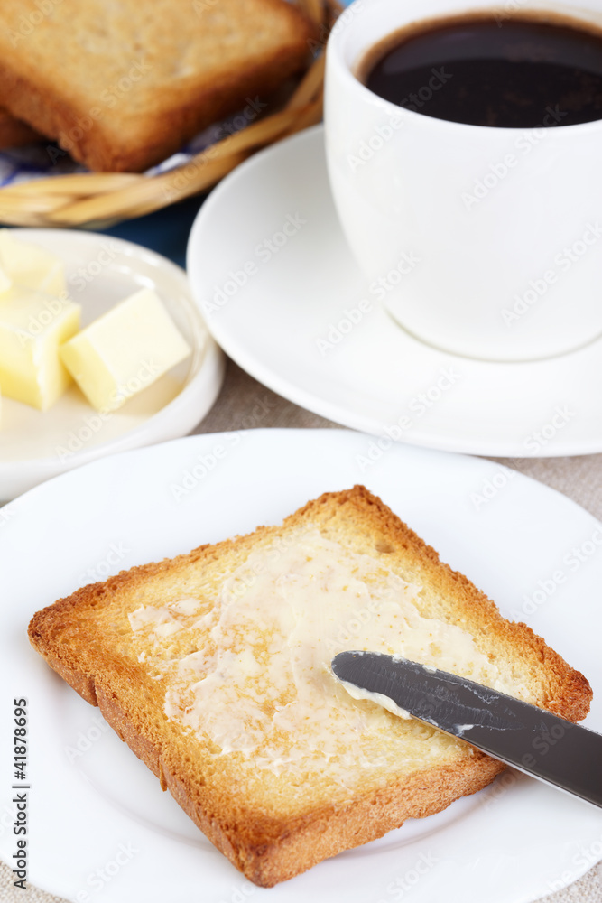 Breakfast. A cup of coffee and toasts with butter Breakfast. A cup of coffee and toasts with butter