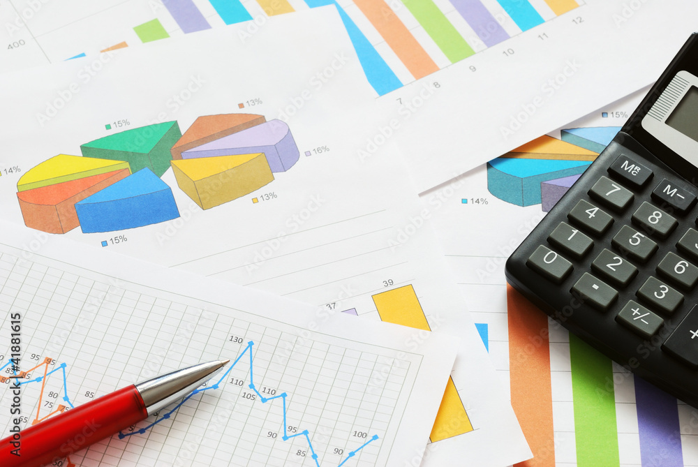Financial documents with red pen and calculator Financial documents with red pen and calculator