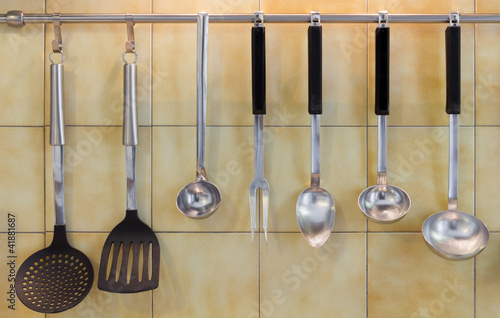 Kitchen tools against a tiled wall