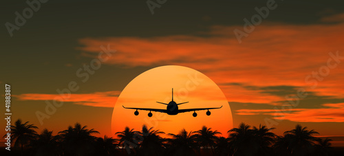 airplane flying at sunset over the tropical land with palm trees