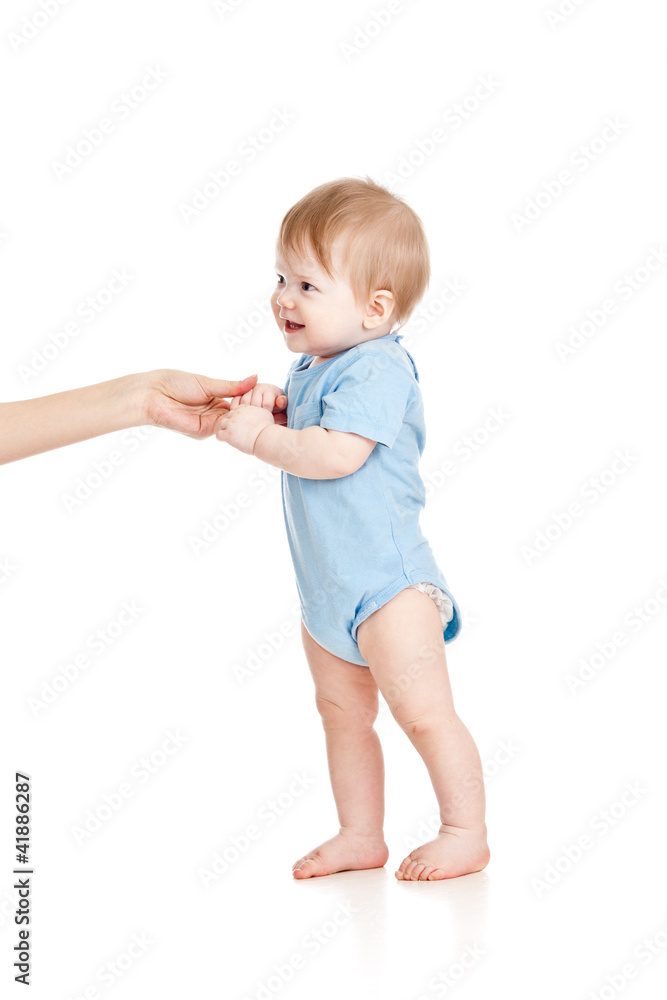 First steps of baby with help of mothers hands First steps of baby with help of mothers hands