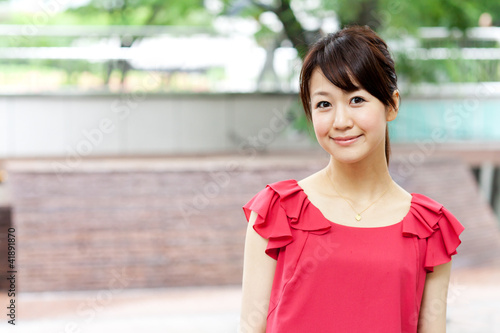 Beautiful young woman on the green. Portrait of asian woman.