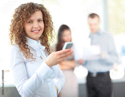Business woman texting on her cell phone and smiling