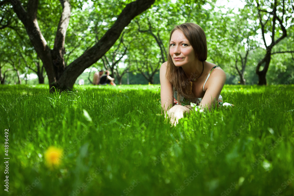 Beautiful woman is lying on the grass Beautiful woman is lying on the grass