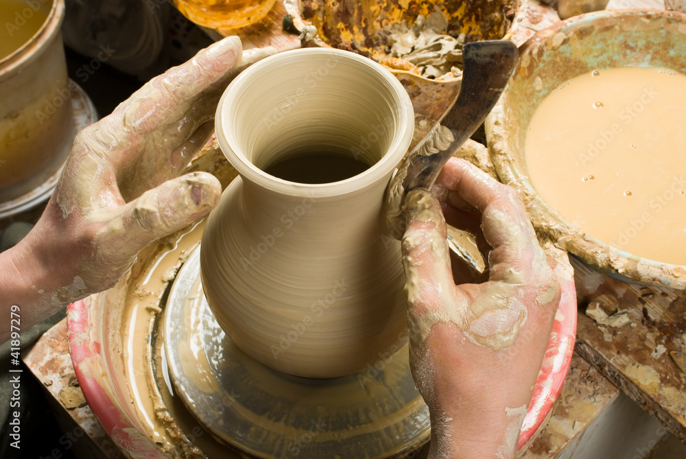 hands of a potter, creating an earthen jar on the circle hands of a potter, creating an earthen jar on the circle