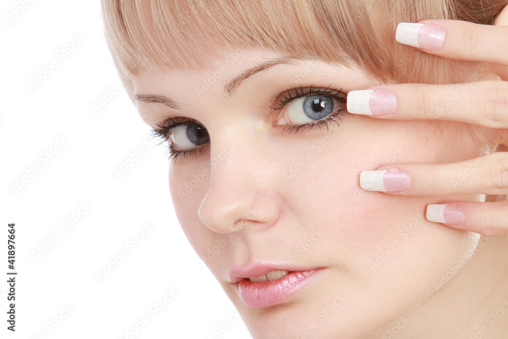 Closeup portrait of a young woman touching her face