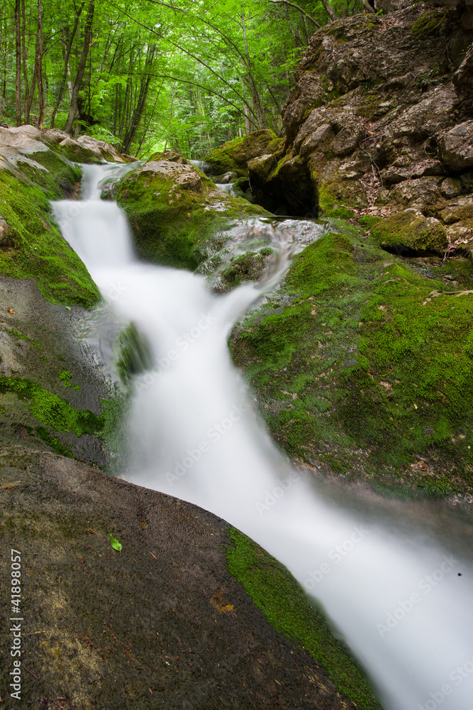 Fototapeta premium nice small waterfall on mountain stream