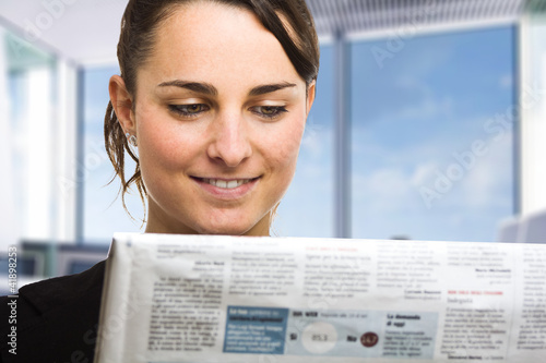 Woman reading a newspaper photo