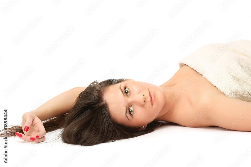A beautiful young woman lying on the floor, isolated on white A beautiful young woman lying on the floor, isolated on white