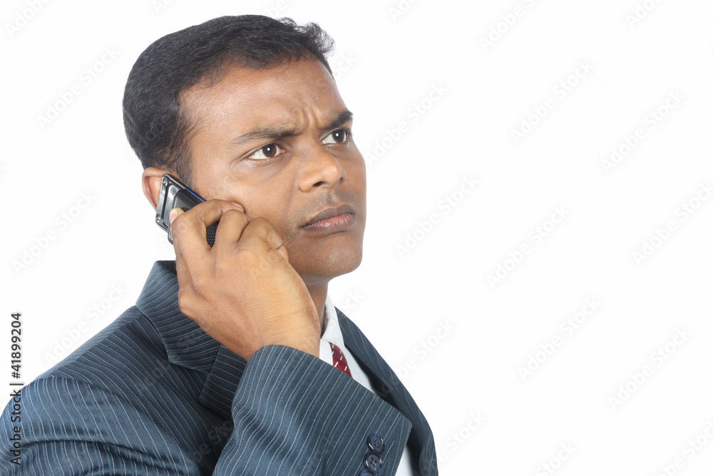 Indian businessman using a mobile phone Indian businessman using a mobile phone