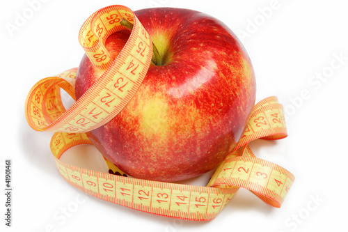 Red apple and measuring tape on a white background.