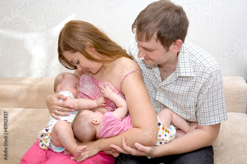 Breast feeding two little sisters twin girls at same time