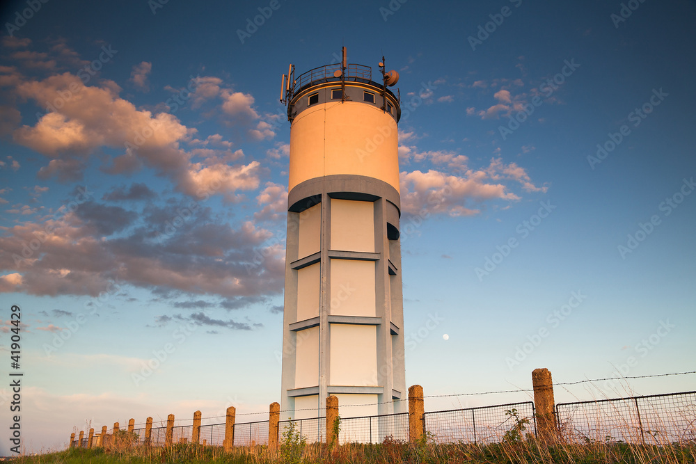 Historic water reservoir brick tower at sunset