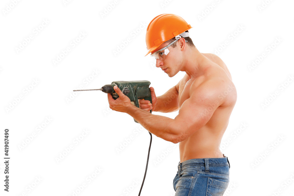A muscular worker with a drill, side-view A muscular worker with a drill, side-view