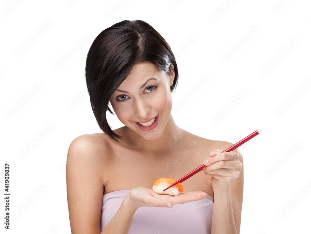 Smiling young female holding sushi with a chopsticks Smiling young female holding sushi with a chopsticks