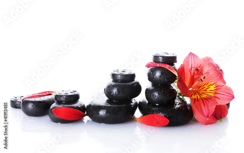Spa stones with drops, red flower and petals isolated on white