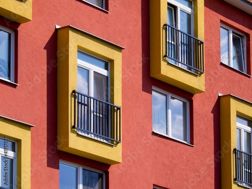 Detail of modern apartments with balconies and red walls