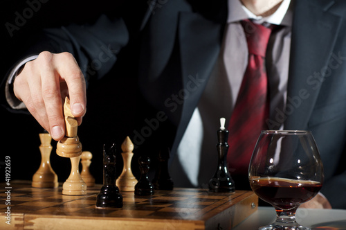 businessman plays chess