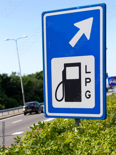 Filling station sign along a highway