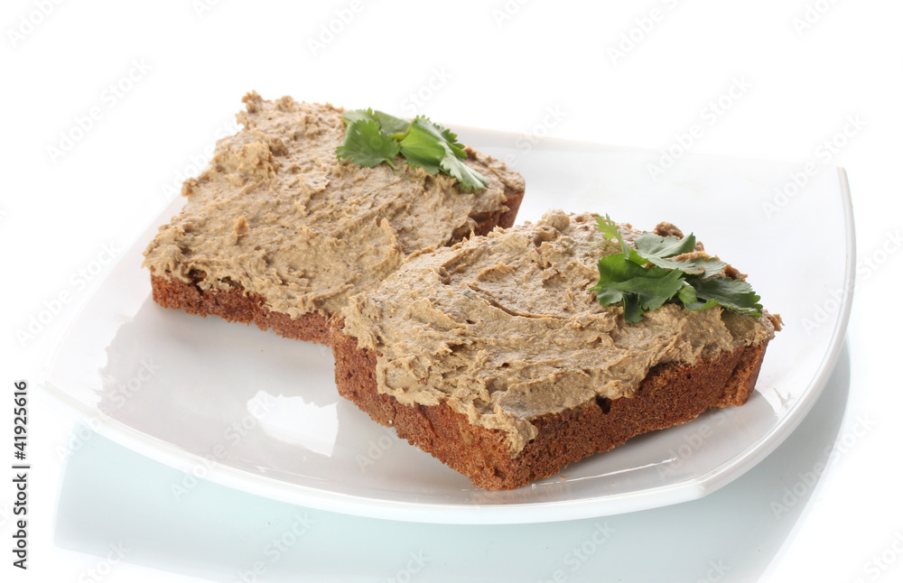 Fresh pate on bread on white plate isolated on white