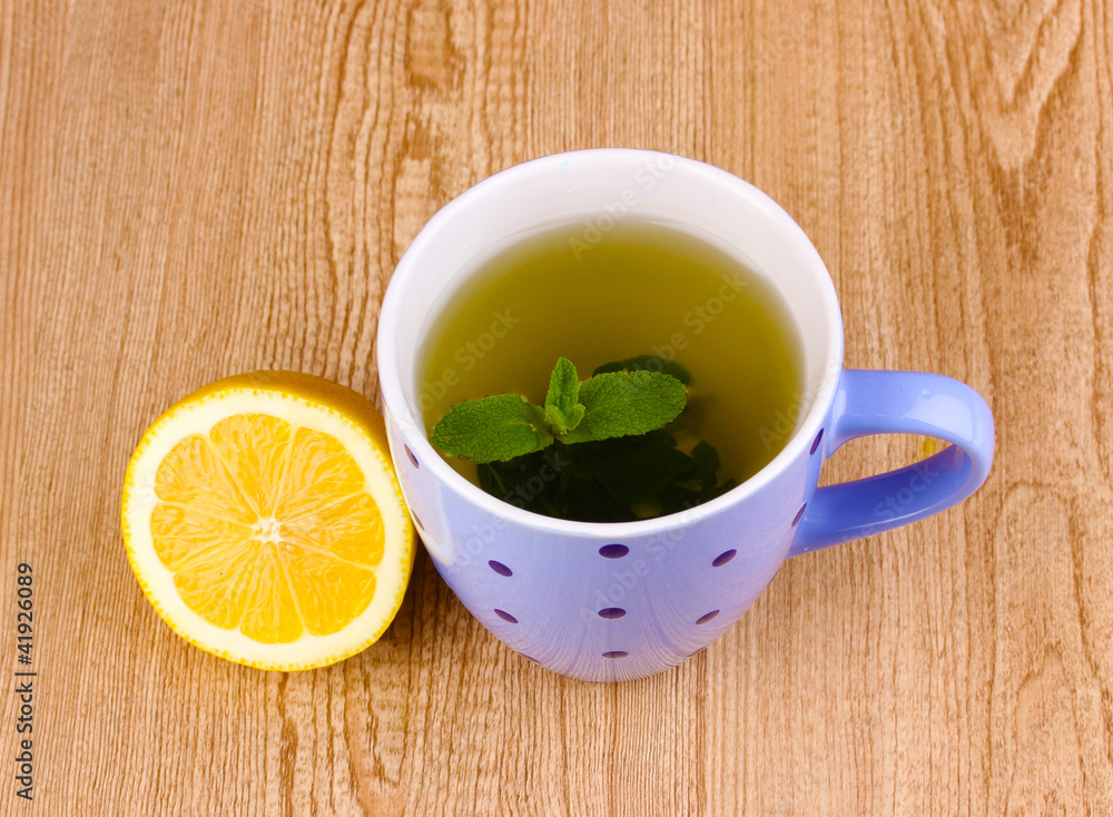Mint tea with mint leaf and lemon on wooden background Mint tea with mint leaf and lemon on wooden background