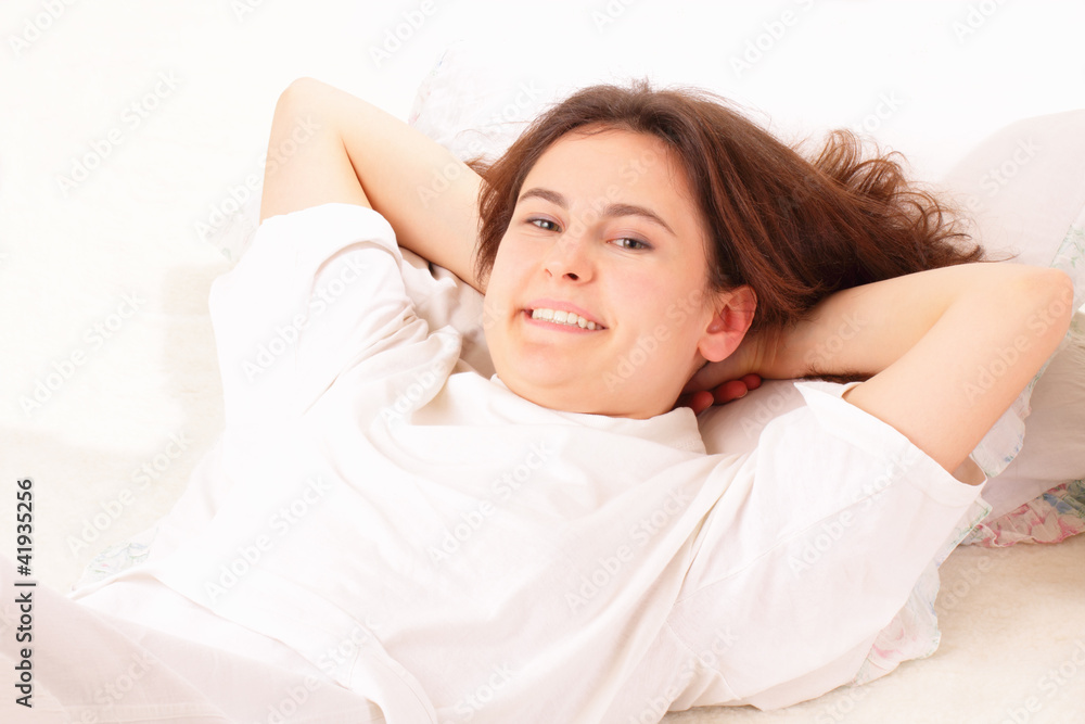 Happy young woman relaxing in bed Happy young woman relaxing in bed