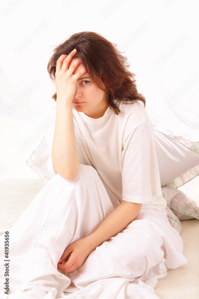 Sick young woman sitting in bed Sick young woman sitting in bed