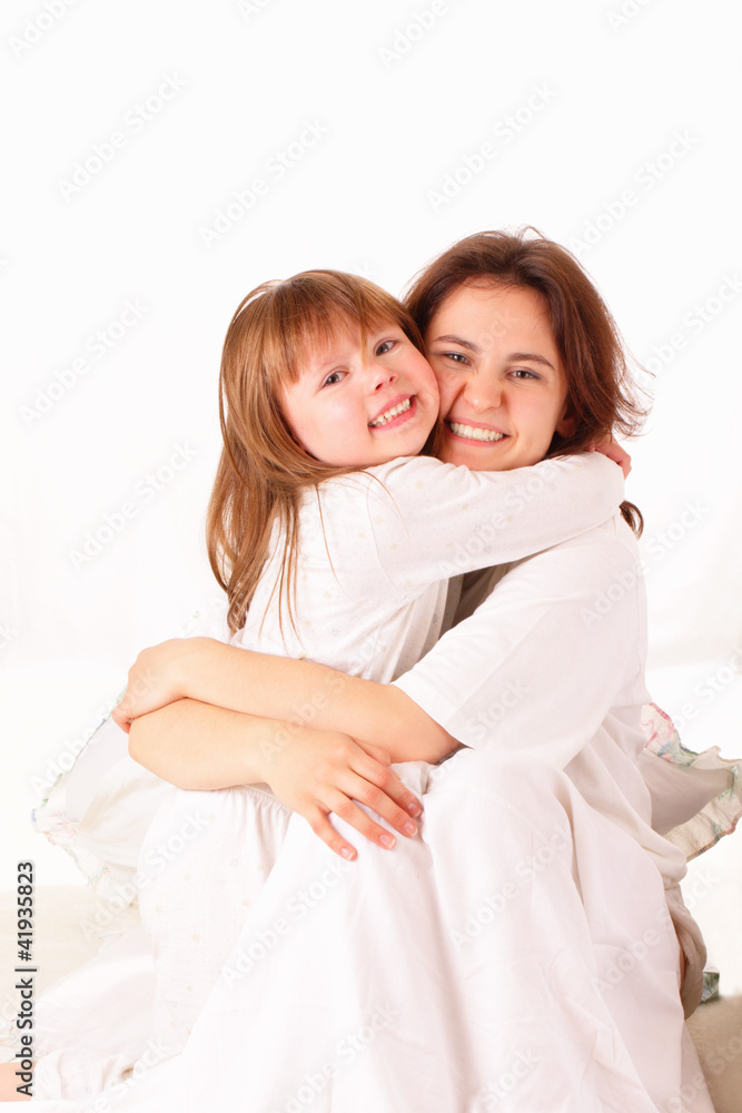 Two happy sisters sitting in bed Two happy sisters sitting in bed