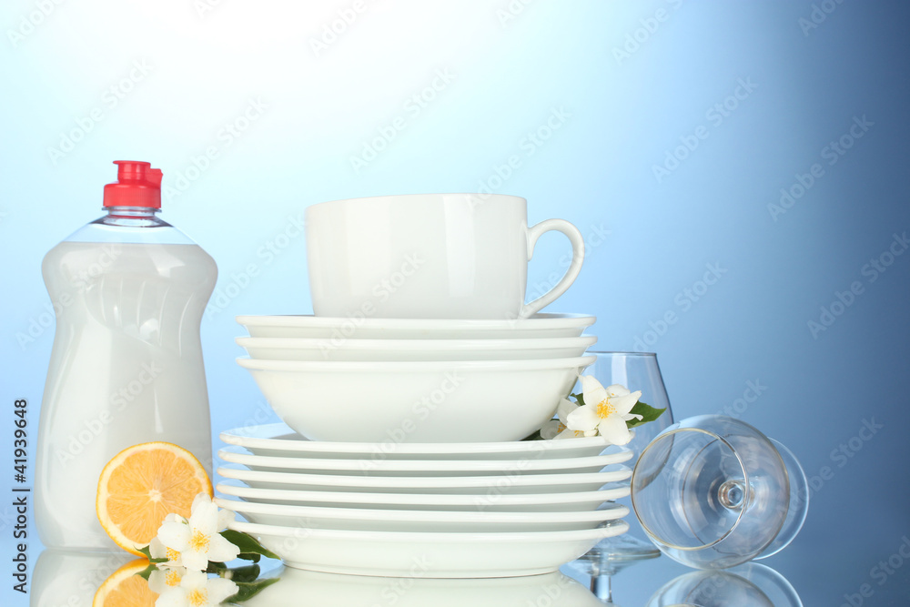 empty clean plates, glasses and cups with dishwashing liquid empty clean plates, glasses and cups with dishwashing liquid