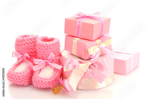 pink baby boots,  pacifier and gifts isolated on white © Africa Studio
