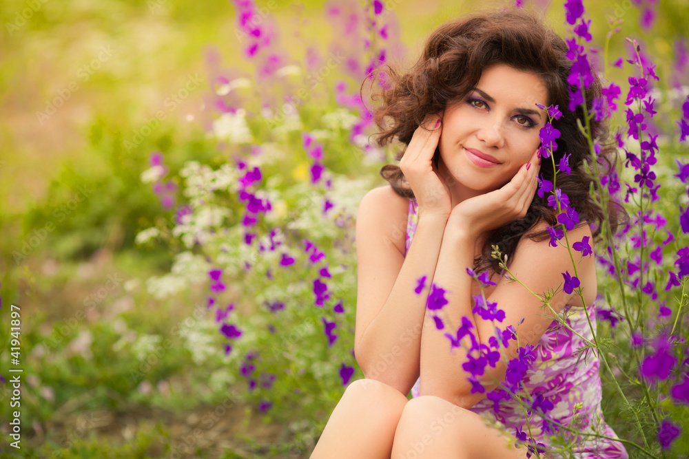Beautiful young woman in purple flowers outdoors Beautiful young woman in purple flowers outdoors