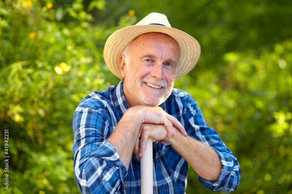 Smiling senior gardener