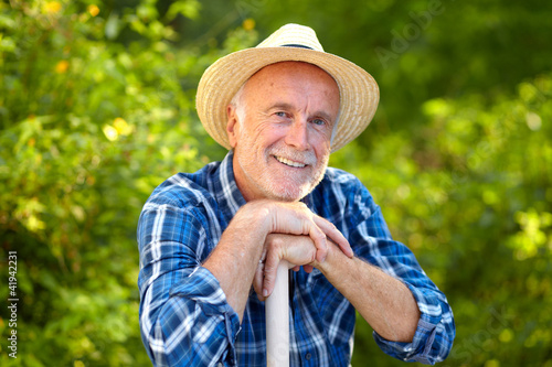 Smiling senior gardener
