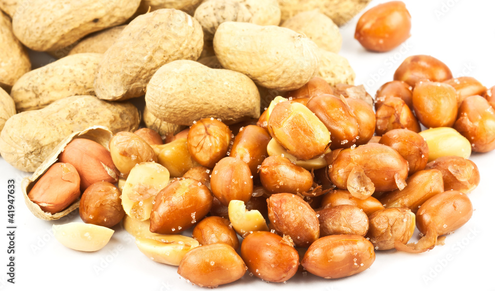 the nuts, peanuts coat the salt on a white background the nuts, peanuts coat the salt on a white background