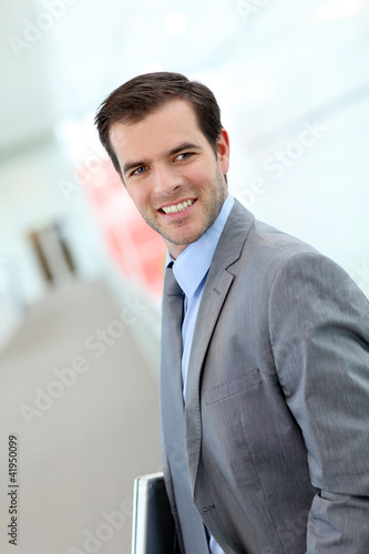 Portrait of businessman standing in hall